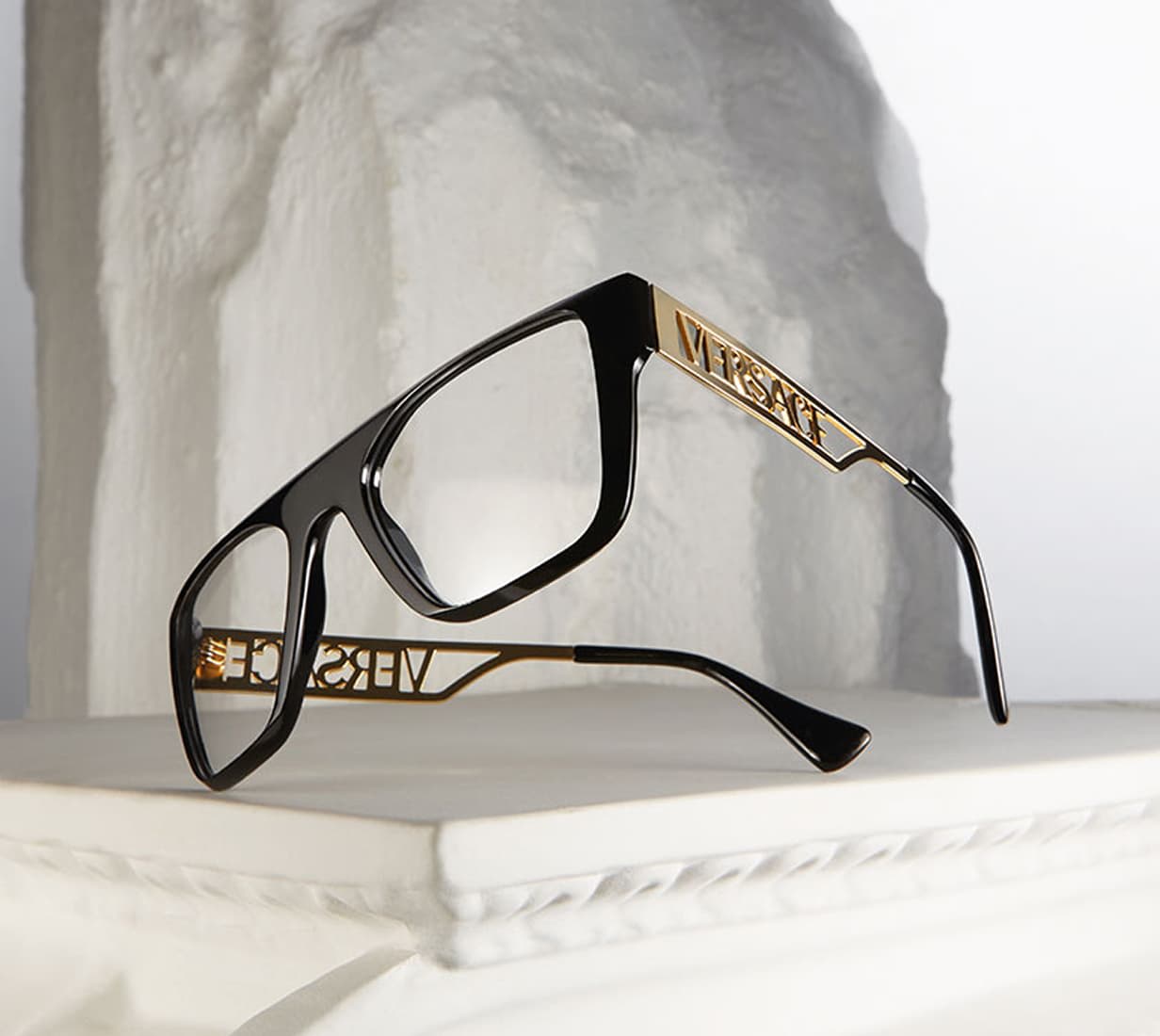 Black luxury eyeglasses with gold accents
